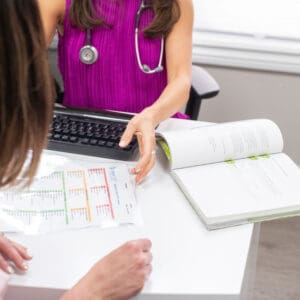 Naturopathic doctor at Hudson Integrative Healthcare reviewing blood test results with a patient during an appointment.