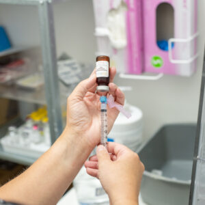 Naturopathic doctor preparing a vitamin B12 injection with a syringe and needle at Hudson Integrative Healthcare.