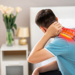 Man experiencing neck and upper back pain with highlighted cervical and upper thoracic spine