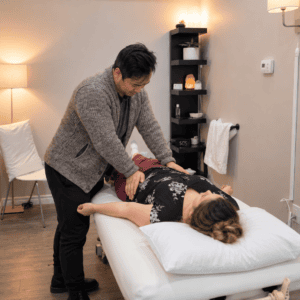 Osteopathic manual practitioner providing hands-on treatment to a patient’s hip and pelvis at Hudson Integrative Healthcare.